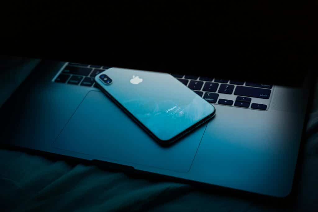 Modern smartphone resting on a laptop, highlighting advanced telecommunications solutions for small businesses in Bristol.