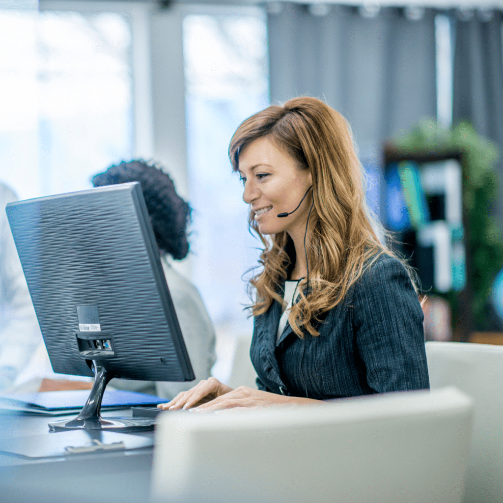 Female support agent using a headset in a modern office, representing Bristol-based telecommunication services for small businesses.